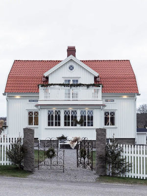 Белый шведский домик, украшенный к зимним праздникам